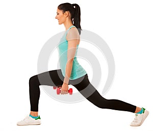 Beautiful young woman doing lunge exercise with red dumbbells in