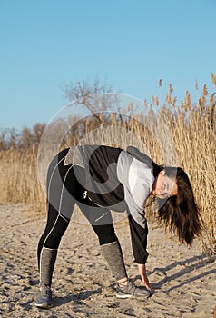 Beautiful young woman doing sports outdoors.