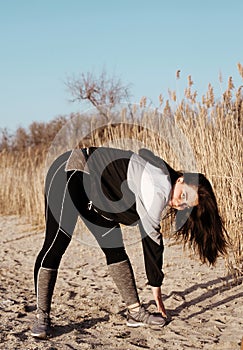 Beautiful young woman doing sports outdoors. Fitness concept.