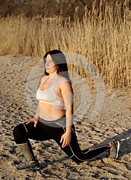 Beautiful young woman doing sports outdoors. Fitness concept.