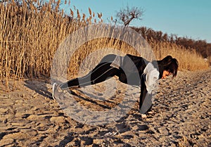 Beautiful young woman doing sports outdoors. Fitness concept.