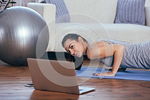 Beautiful young woman doing workout at home