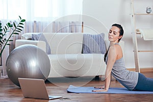 Beautiful young woman doing workout at home