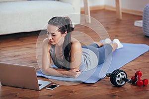 Beautiful young woman doing workout at home