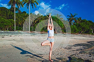 Beautiful young woman doing yoga exercise