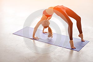 Beautiful young woman doing yoga exercise Bridge Pose