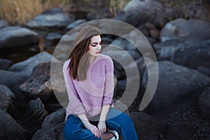 Beautiful young woman. Dramatic outdoor portrait of sensual brunette female with long hair. Sad and serious girl.