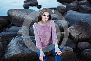 Beautiful young woman. Dramatic outdoor portrait of sensual brunette female with long hair. Sad and serious girl.