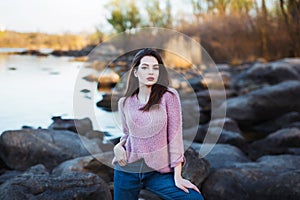 Beautiful young woman. Dramatic outdoor portrait of sensual brunette female with long hair. Sad and serious girl.