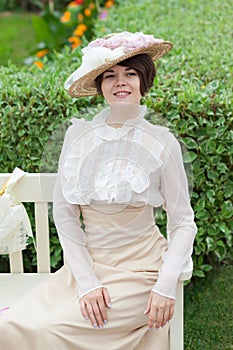 Beautiful young woman in dress and hat portrait in retro style. Vogue dressing in vintage