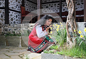 Beautiful young woman dressed in a traditional folklore costume