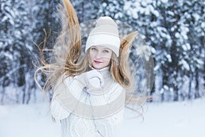 Beautiful young woman dressed warmly in winter Park