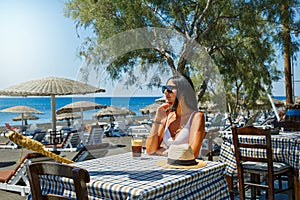 Beautiful young woman  drinking a coffee cocktail