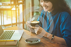 Beautiful young woman drinking coffee and smile