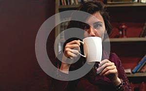 Beautiful Young Woman Drinking Coffee or Tea. Girl Start drinking decaffeinated drinks and enjoying this beverage. Lady