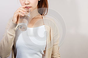 Beautiful young woman drinking a fresh glass of water