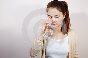Beautiful young woman drinking a fresh glass of water