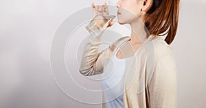 Beautiful young woman drinking a fresh glass of water