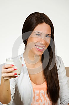 Beautiful young woman drinking milk