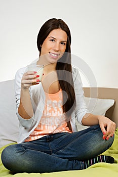 Beautiful young woman drinking milk