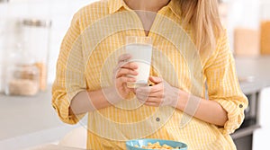 Beautiful young woman drinking milk