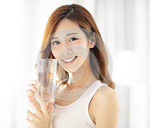 Beautiful young woman drinking water