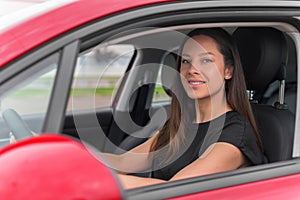 Beautiful young woman driving a car.