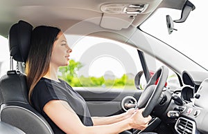 Beautiful young woman driving a car.