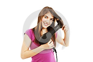 Beautiful young woman drying her hair with drier
