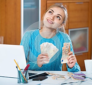 Beautiful young woman earning money being freelancer