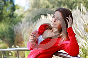 Beautiful young woman eating apple.