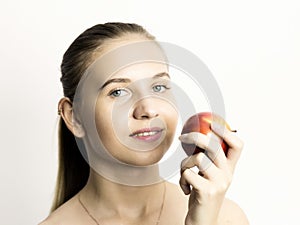 Beautiful young woman eating an apple. healthy food - strong teeth concept