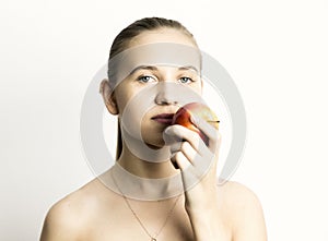 Beautiful young woman eating an apple. healthy food - strong teeth concept