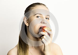 Beautiful young woman eating an apple. healthy food - strong teeth concept