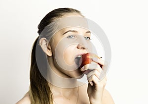Beautiful young woman eating an apple. healthy food - strong teeth concept