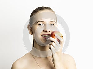 Beautiful young woman eating an apple. healthy food - strong teeth concept