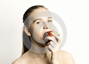 Beautiful young woman eating an apple. healthy food - strong teeth concept