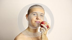 Beautiful young woman eating an apple. healthy food - strong teeth concept