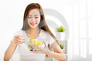 Beautiful young woman eating healthy food