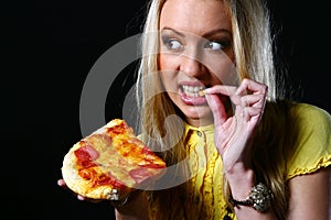 Beautiful young woman eating pizza