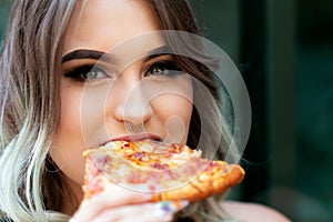 Beautiful Young Woman eating Slice of hot  Pizza. Popular Fast Food concept.