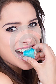 Beautiful young woman eating sushi roll