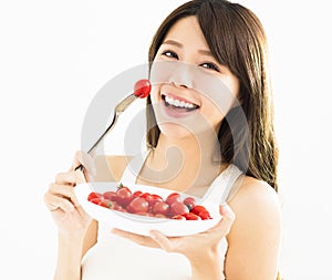 Beautiful Young Woman Eating Tomatoes