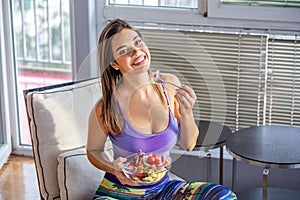 Beautiful Young Woman Eating Vegetable Salad . Healthy Diet. Beautiful Smiling Woman Eating Fresh Organic Vegetarian Salad.