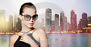 Beautiful young woman in elegant black sunglasses