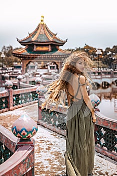 beautiful young woman in elegant dress at temple