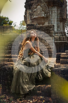 beautiful young woman in elegant dress at temple