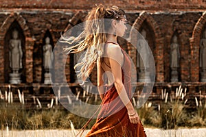 beautiful young woman in elegant dress at temple