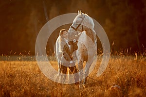 Beautiful young woman in English hunter wear style with Knabstrupper horse