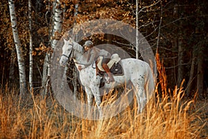 Beautiful young woman in English hunter wear style with Knabstrupper horse